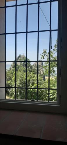 a window with a view of a mountain view at Il Castellaro ai Sassi in Guiglia