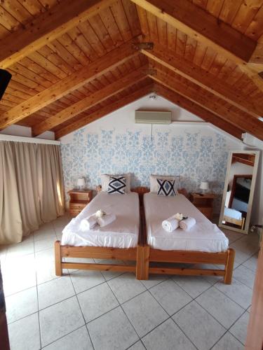 a bedroom with a bed with towels on it at Chloe attic in Agia Effimia