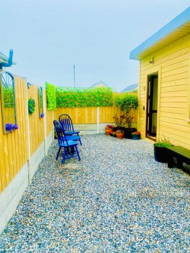 a blue bench sitting on a patio next to a fence at Lavender Lodge in Kilmore Quay