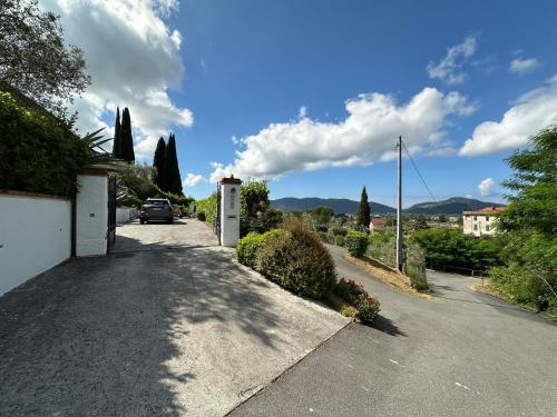 a road with a car parked on the side at Villa Camilla 10 Pax by VILLASRETREATS in Sarzana