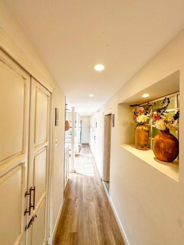a hallway of a house with flowers on the walls at Hotel Posada de Santa Elena in Tunja