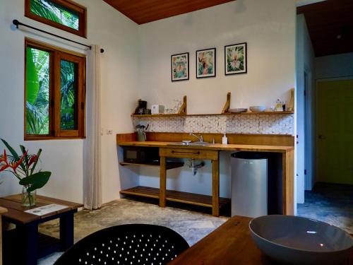 a kitchen with a wooden table and a sink at Casa Salvaje Vacation Rentals in Bocas del Toro