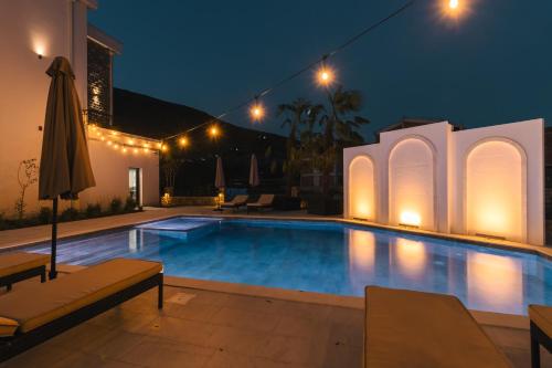a swimming pool in a villa at night at CAROLEA VILLAS in Ulcinj