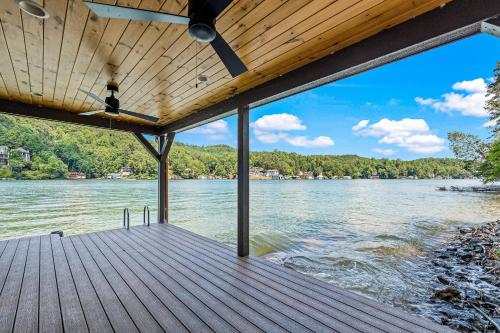 a wooden dock with a view of a lake at Water's Edge Holmstead in Lake Lure