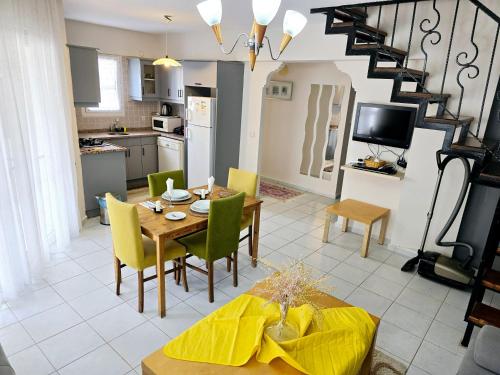 a kitchen and dining room with a table and chairs at 3 Bedrooms Apartment in Ölüdeniz, Ovacik in Oludeniz