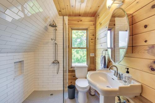 a bathroom with a toilet and a sink and a mirror at Home with Fire Pit on 27 Acres in Walhalla! in Walhalla