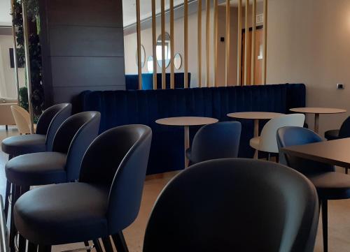 a row of tables and chairs in a restaurant at Crowne Plaza Milan - Malpensa Airport by IHG in Case Nuove