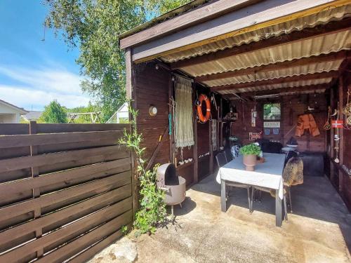 a patio with a table and a fence at 10 person holiday home in Ålbæk-By Traum in Ålbæk