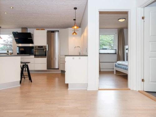 a kitchen with white cabinets and a counter top at 5 star holiday home in Vinderup-By Traum in Vinderup