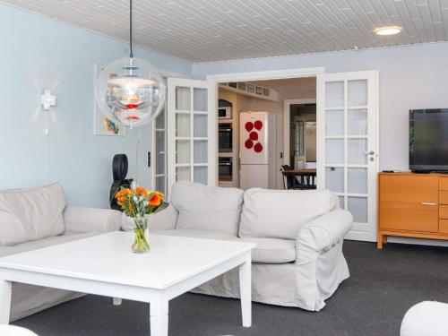 a living room with white couches and a table at 10 person holiday home in Thyborøn-By Traum in Thyborøn