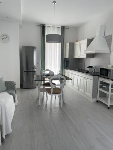 a kitchen with a table and a dining room at MAISON ANGELINA - Elegante Casa Vacanze in Puglia con Charme e Comfort in Grumo Appula
