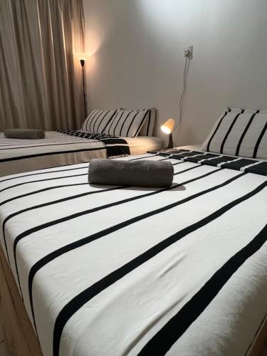 two large beds in a room withskirts at 7 STAY#2 - 1 Room for 3 Pax at Kuala Berang -Best Travelers Stay in Kuala Berang
