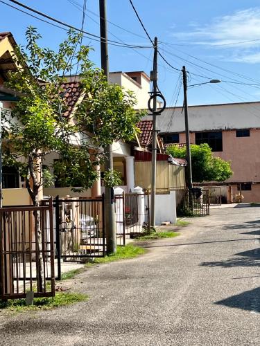 an empty street with a fence and houses at 7 STAY#2 - 1 Room for 3 Pax at Kuala Berang -Best Travelers Stay in Kuala Berang