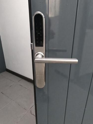 a stainless steel refrigerator door with a handle at Casa Senhora Da Estrela 1, 2 or 3 bedrooms in Ribeira Grande