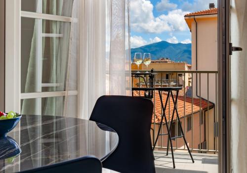 a balcony with a table and a view of a city at Tower View luxury apartment on the River in Pisa