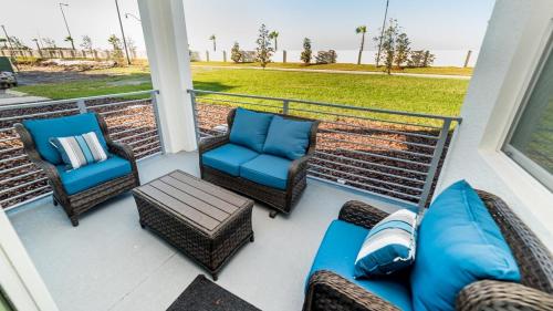 a porch with chairs and a couch and a table at The Monochrome in Orlando