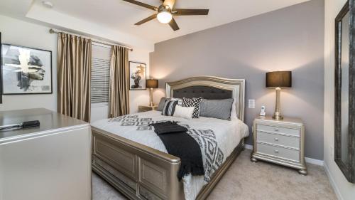 a bedroom with a bed and a ceiling fan at The Monochrome in Orlando