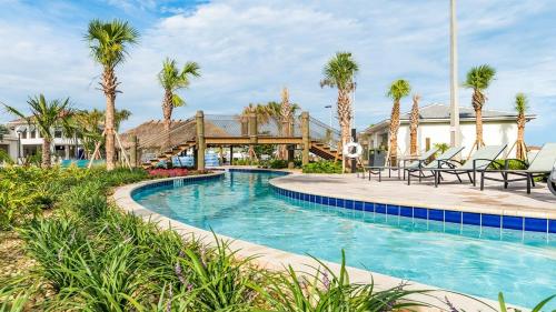 a pool at a resort with palm trees at The Monochrome in Orlando
