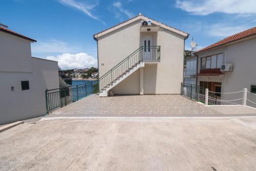 a large building with a staircase on the side at Apartments Ivica in Primošten
