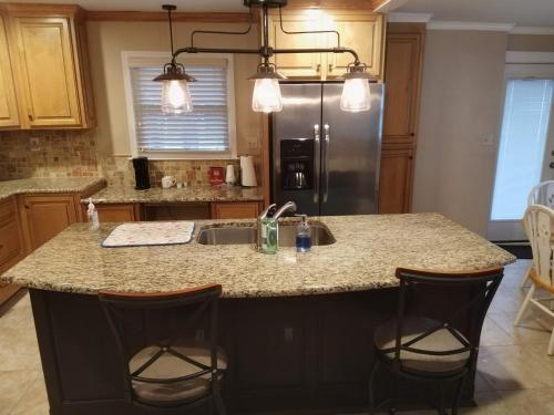 a kitchen with a sink and a refrigerator at Queen city lifestyle in Charlotte