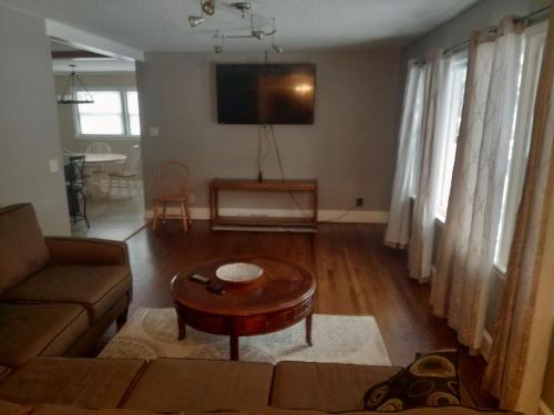 a living room with a couch and a table at Queen city lifestyle in Charlotte