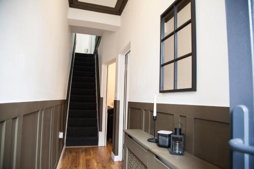 a hallway with a staircase in a house at Entire Modern Home in Manchester and Near Peak District in Manchester
