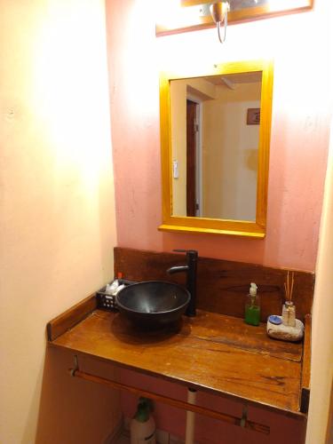 a bathroom with a sink and a mirror at Cabaña Los Cardones in Campanas