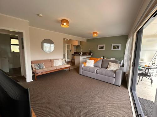 a living room with a couch and a table at Time on Tilsley in Rotorua