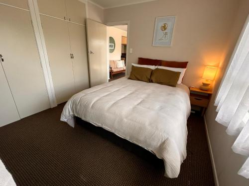 a bedroom with a large white bed with two pillows at Time on Tilsley in Rotorua