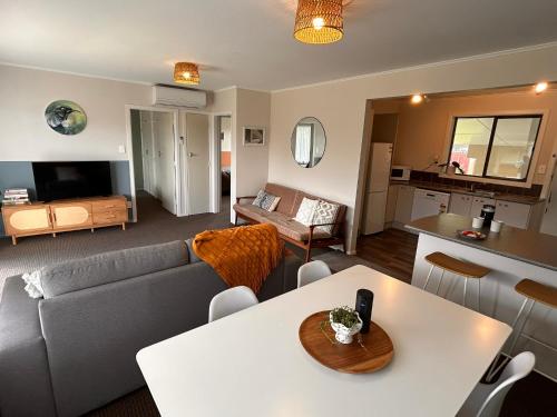 a living room with a couch and a table at Time on Tilsley in Rotorua