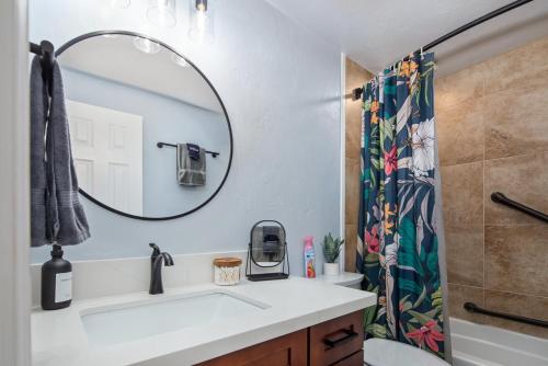 a bathroom with a sink and a mirror at Ocean-front penthouse, sunsets, whales, surfers! Newly remodeled! in Kailua-Kona