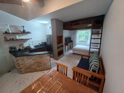 an overhead view of a kitchen with a table and a dining room at Flat Maresias in São Sebastião