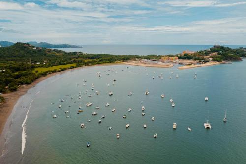 an aerial view of a harbor with boats in the water at Flamingo Marina Cove 404- Oceanfront Condo in Playa Flamingo