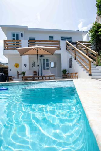 a swimming pool in front of a house at Casa Rosado Rincon Rayo Suite Mountain View Pool in Rincon