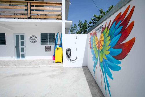 a wall with a painting of a surfboard on it at Casa Rosado Rincon Rayo Suite Mountain View Pool in Rincon