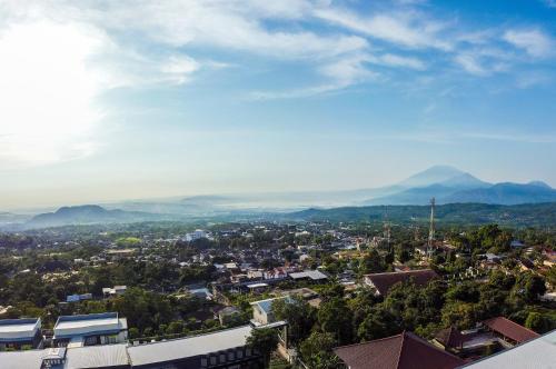 a view of a city with mountains in the background at Griya Persada Convention Hotel & Resort Bandungan in Bandungan