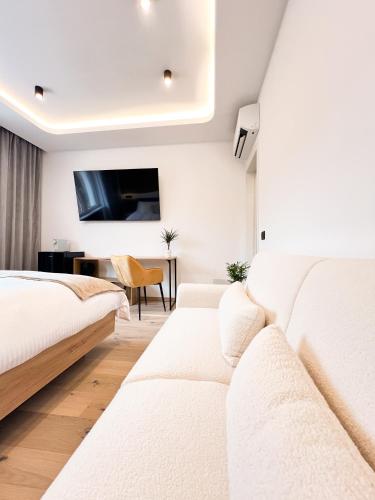 a bedroom with two beds and a couch at Milan Boutique Villa in Paderno Dugnano