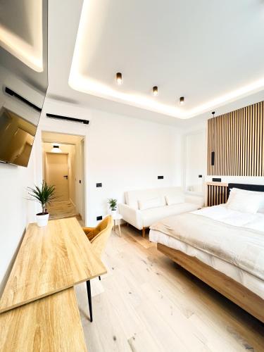 a bedroom with a bed and a couch and a table at Milan Boutique Villa in Paderno Dugnano