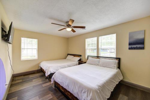 a bedroom with two beds and a ceiling fan at Indoor fireplace with patio and Pool Table in Beaumont
