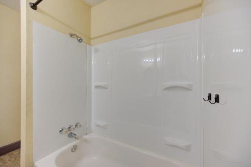 a white bathroom with a shower and a sink at Indoor fireplace with patio and Pool Table in Beaumont