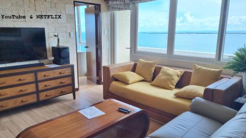 a living room with a couch and a television at La Mirada Residences in Mactan