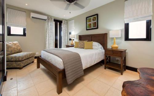 a bedroom with a bed and a chair and a couch at Casa Calle La Ronda At Las Catalinas in Playa Danta