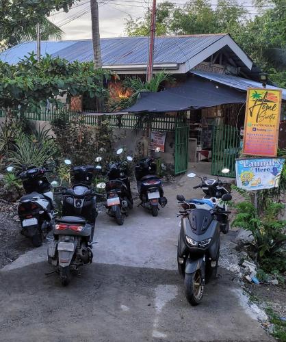 a group of motorcycles parked in front of a store at Home Sweetie Homestay & Bunkbeds in Moalboal