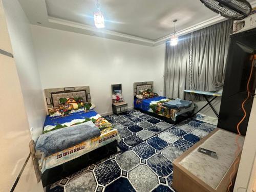 a bedroom with two beds and a floor at فيلا مودرن حديثة للإيجار in King Mariout