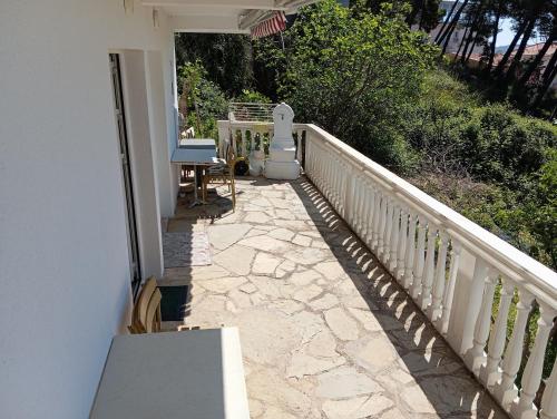 a balcony of a house with a stone walkway at ZaraByTheSea3 in Brca