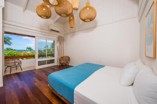 a bedroom with a bed and a large window at Villa Flamingo 8 At Playa Flamingo in Playa Flamingo