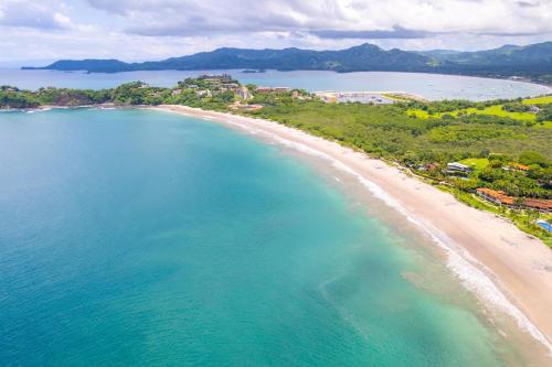 an aerial view of a beach and the ocean at 360 Splendor 105A-Ocean View 2 Br Condo-Breakfast Included! in Playa Flamingo