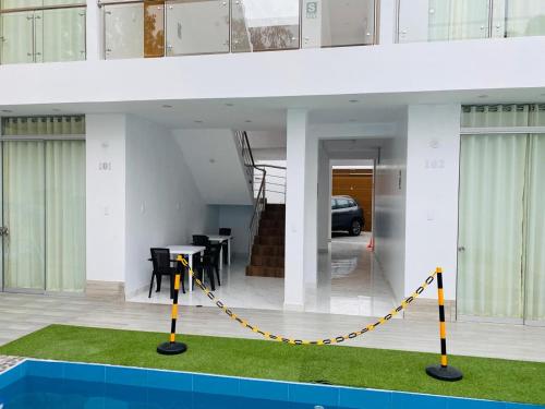 a house with a yellow chain around the front of it at Hurin Hotel in Ica