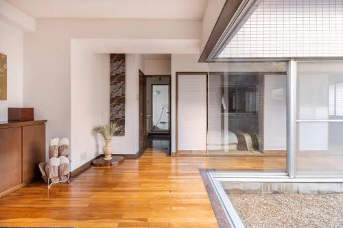 an empty living room with a large glass window at Private Japanese garden,130m2, Ikebukuro Shinjuku Shibuya 5-15min , 200 restaurants nearby, 7-11 in front in Tokyo