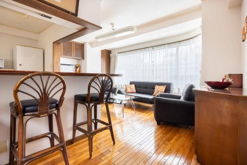 a living room with two chairs and a couch at Private Japanese garden,130m2, Ikebukuro Shinjuku Shibuya 5-15min , 200 restaurants nearby, 7-11 in front in Tokyo